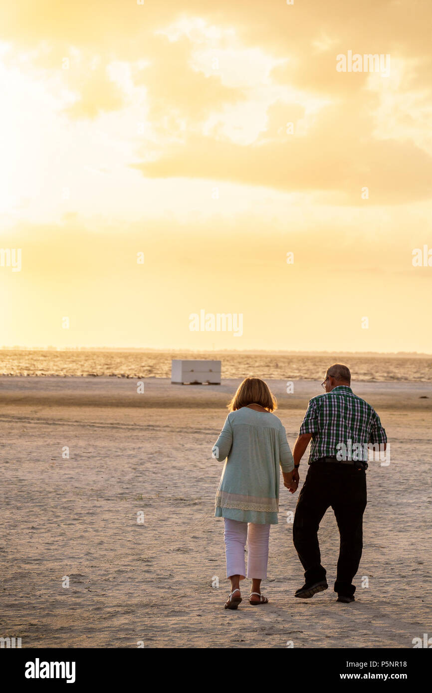 Florida,Fort Ft. Myers Beach,sand,man men male,woman female women,couple,holding hands,walking,Gulf of Mexico,mature,romantic,FL170925080 Stock Photo