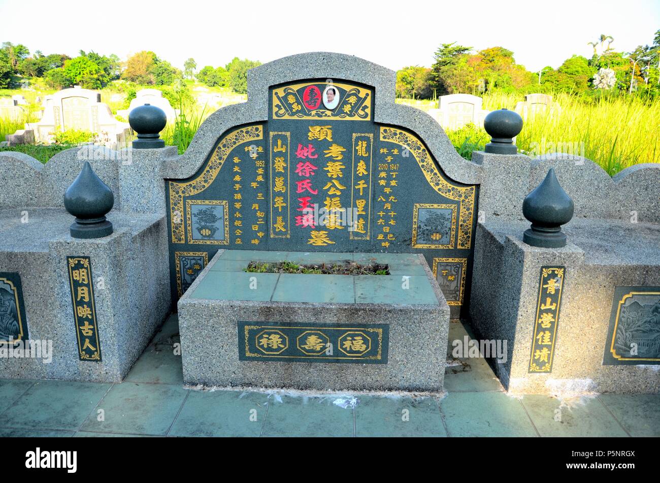 Chinese grave tombstone with photograph and etched artistic tiles Ipoh