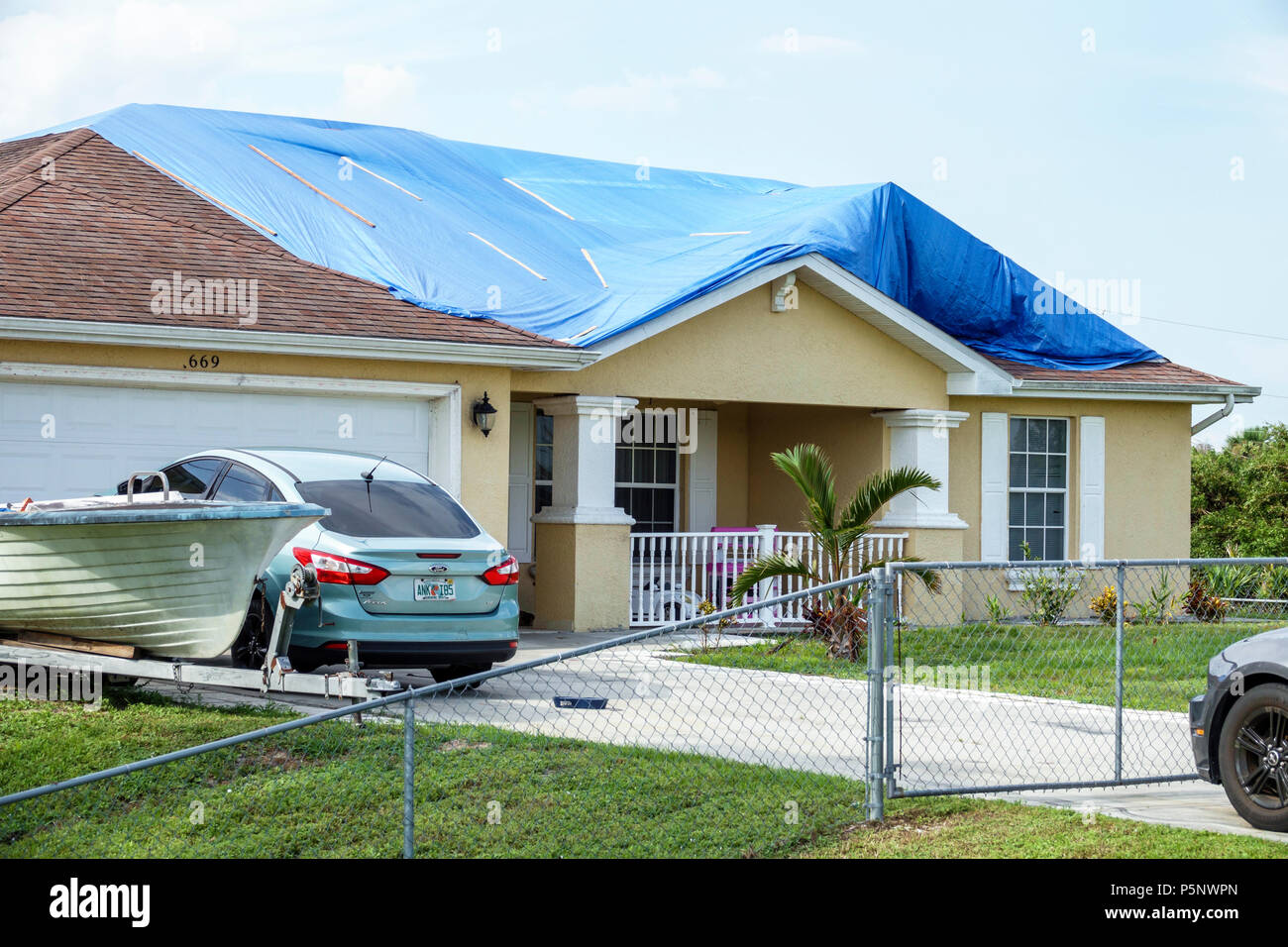 Fort Ft. Myers Florida,Lehigh Acres,after Hurricane Irma storm wind damage destruction aftermath,blue tarp waterproof covering roof,house home houses Stock Photo