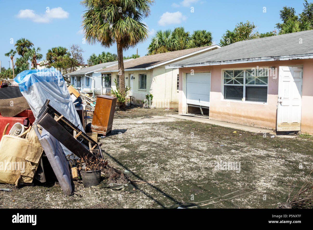 Florida,Bonita Springs,after Hurricane Irma storm water damage destruction aftermath,flooding,house home,front yard,debris trash pile,damaged furnitur Stock Photo