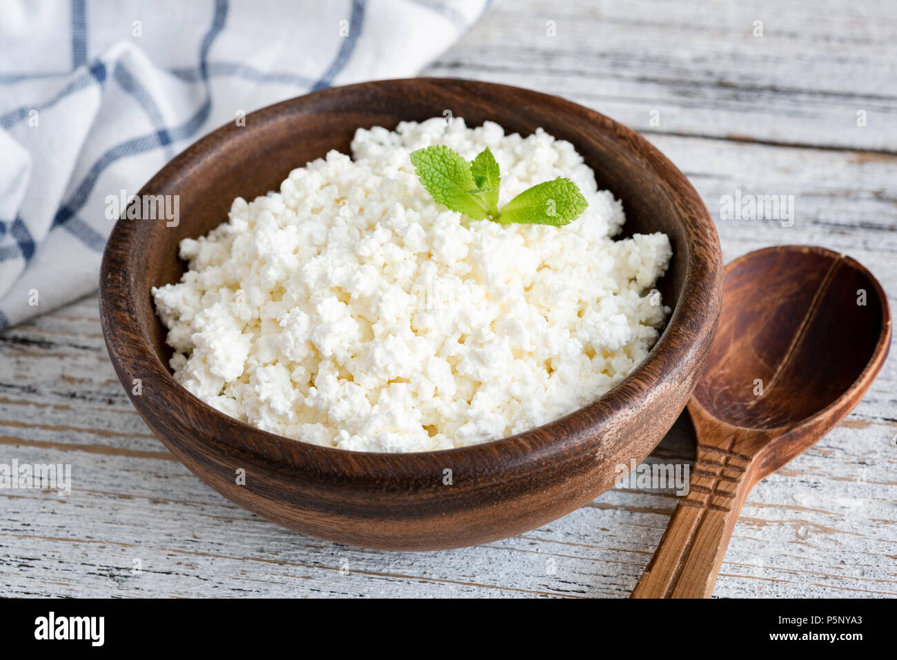 Cottage Cheese Ricotta Or Tvorog In Wooden Bowl On White Table