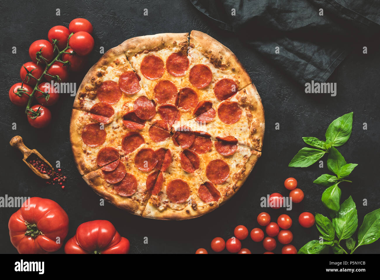 Tasty pepperoni pizza on black concrete background, top view Stock Photo