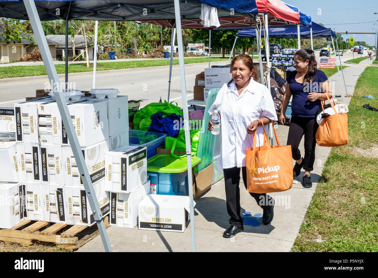 Florida,Bonita Springs,after Hurricane Irma storm damage destruction aftermath,disaster relief recovery,donations distribution site point,Hispanic wom Stock Photo