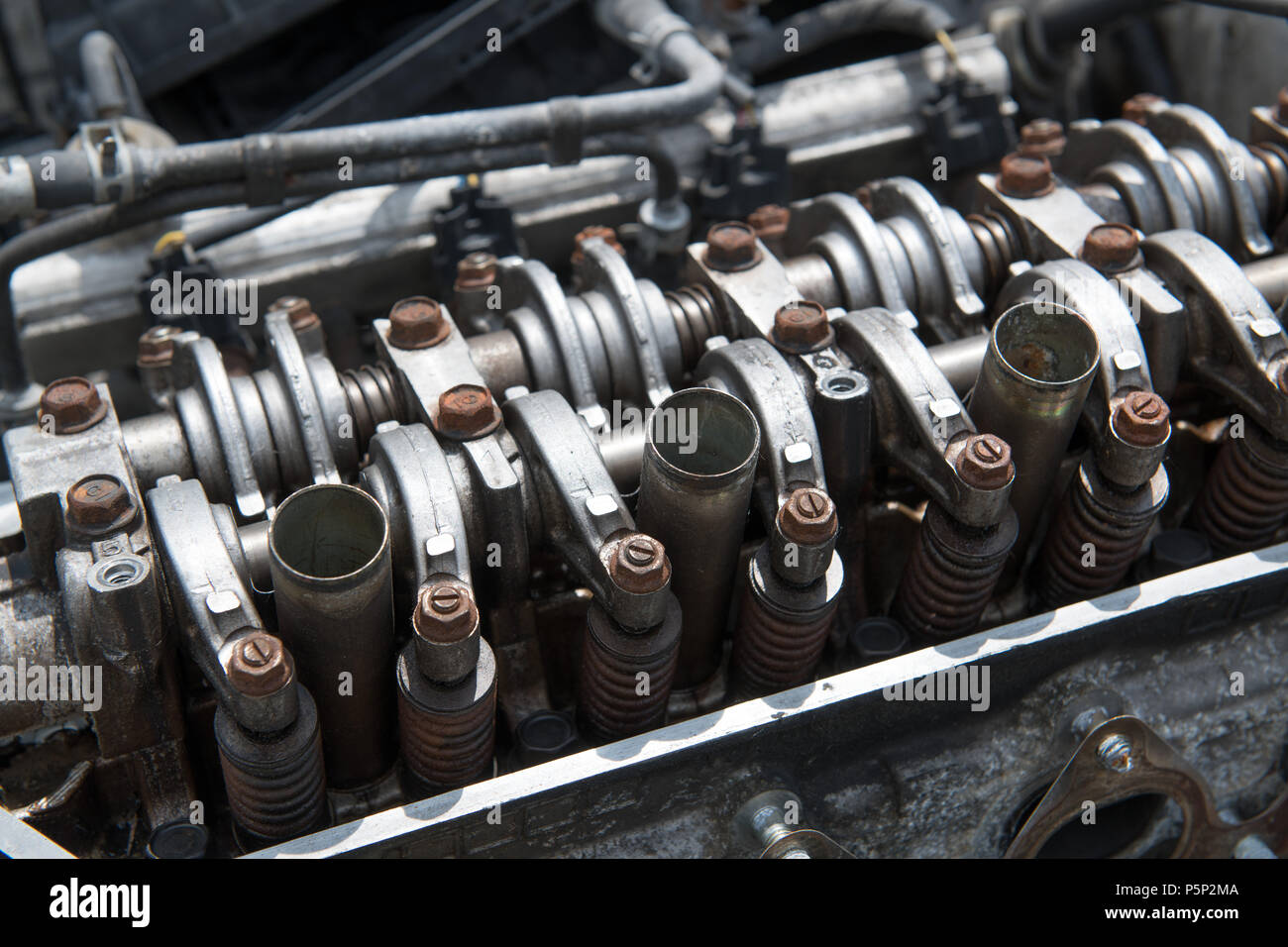 An open engine block with rusted bolts reveals the four cylinders of the engine Stock Photo