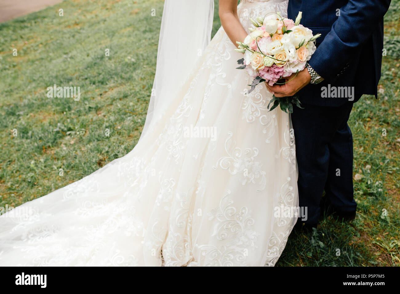 bouquet in the hands of the bride and groom Stock Photo - Alamy