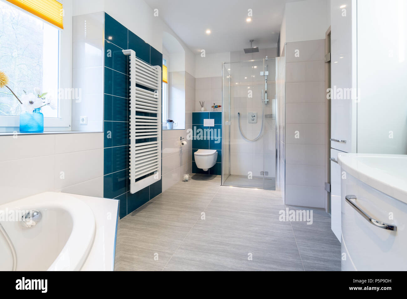 Spacious Bathroom In Blue And White Tones With Heated Floors