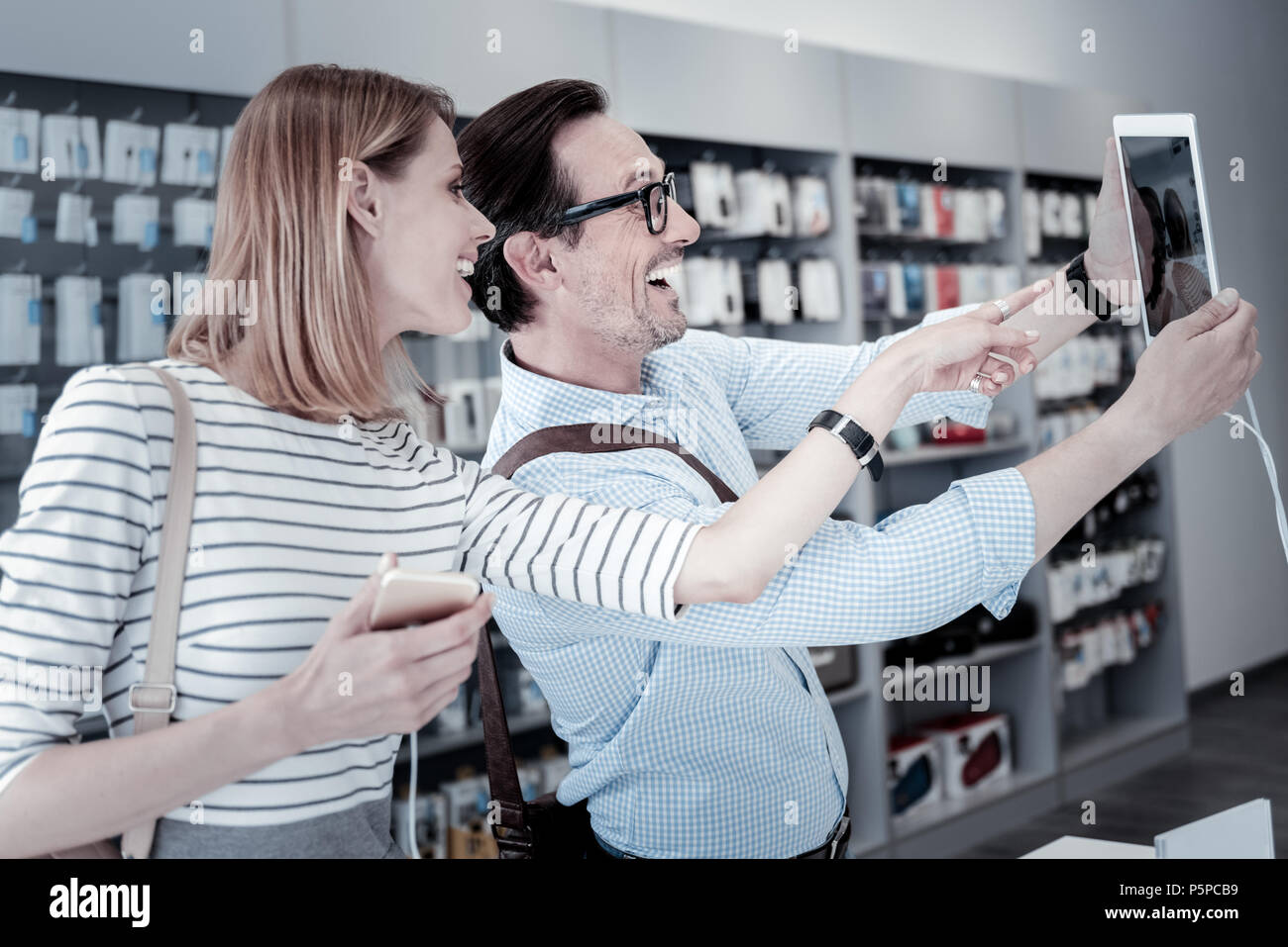 Cute funny people taking a photo in a store Stock Photo
