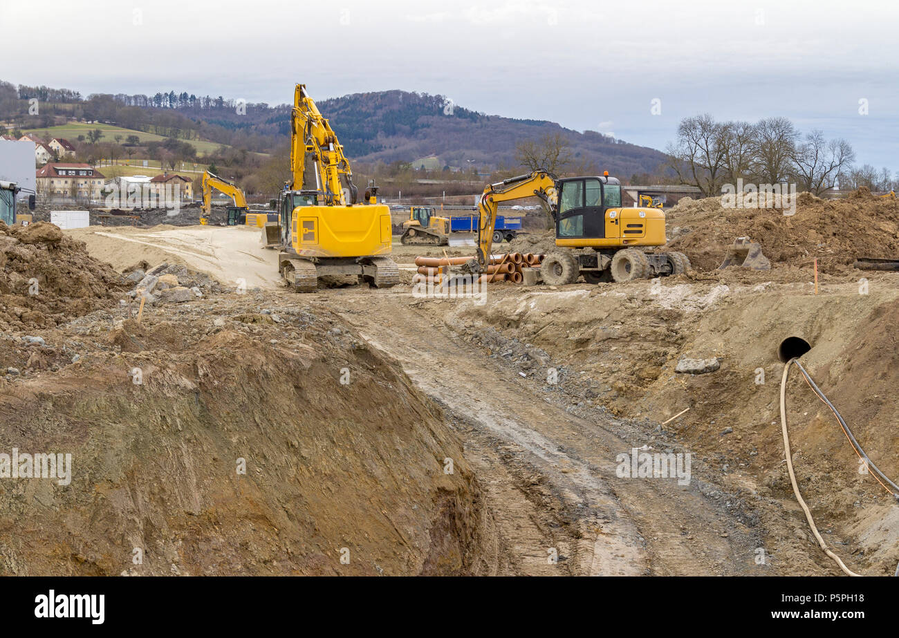 excavators at a loamy construction site Stock Photo - Alamy
