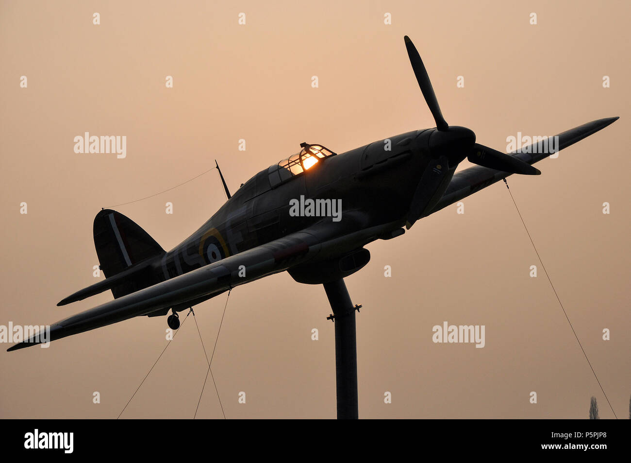 Hawker Hurricane replica gate guardian at North Weald airfield, former RAF Royal Air Force Battle of Britain Second World War airbase. Dusk. Sunset Stock Photo