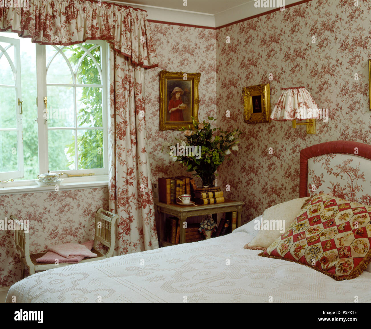 Co Ordinating Floral Wallpaper And Curtains In Country Bedroom