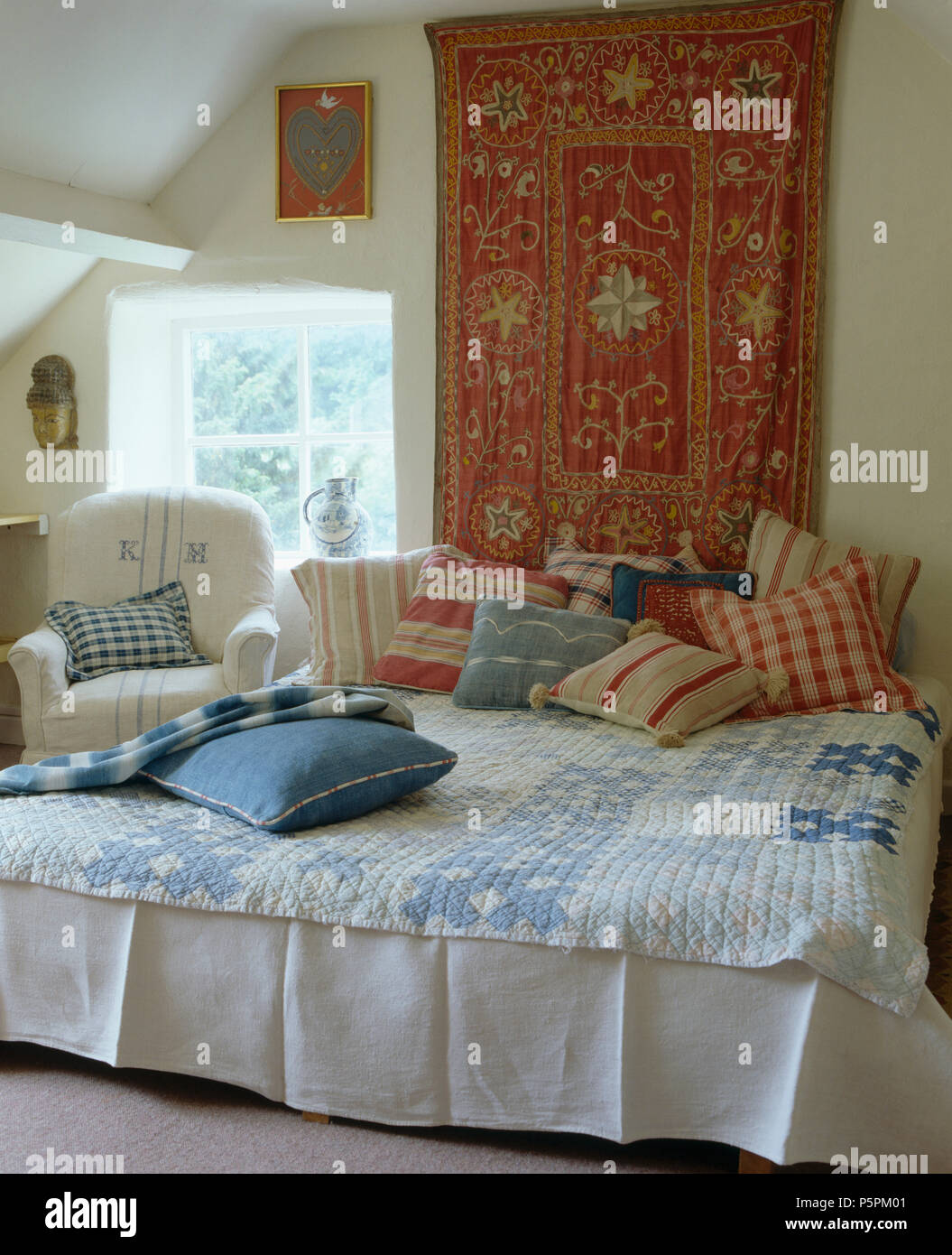 Country Bedroom Indian Style Wall Hanging Above Bed Piled With Red