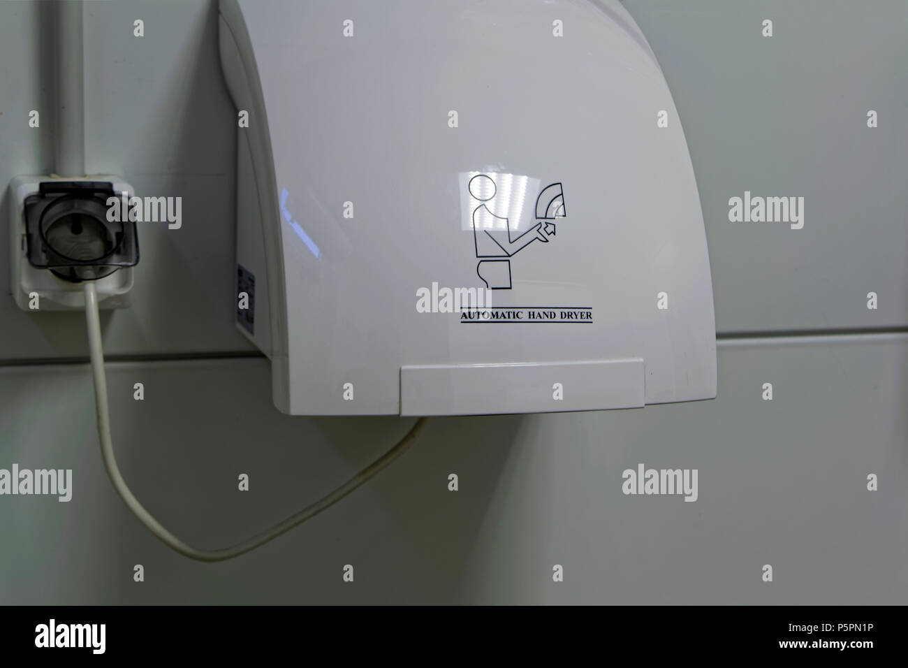 Modern vertical hand dryer in public restroom WC Stock Photo Alamy