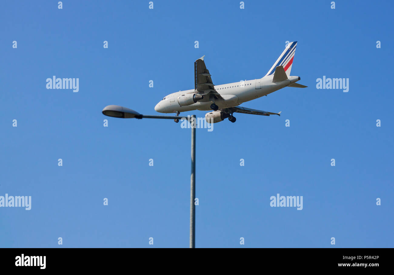 Passenger airplane shot from below closed to a pylon against a