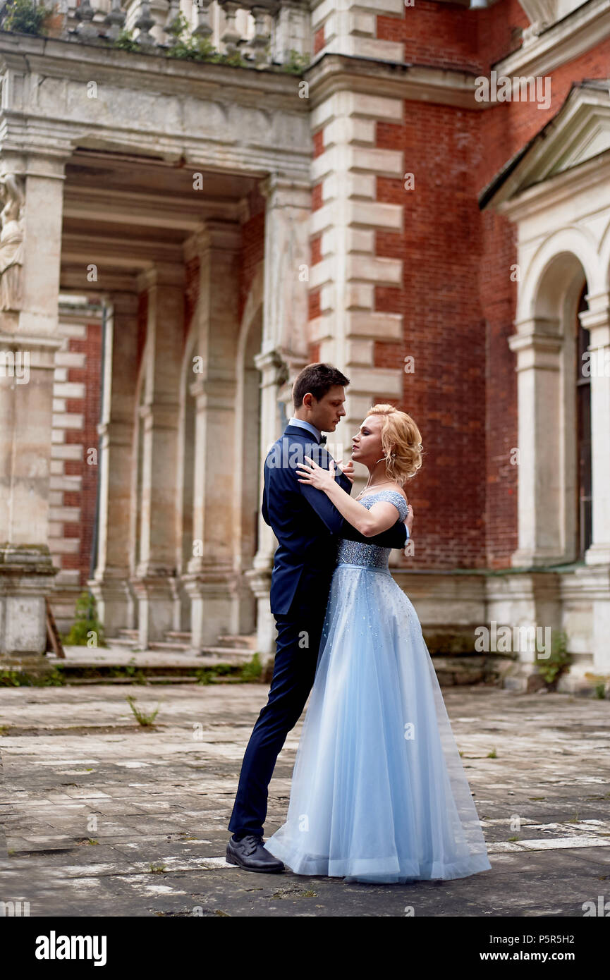 The Bride And Groom Dancing Around The Columns Of The Old Estate