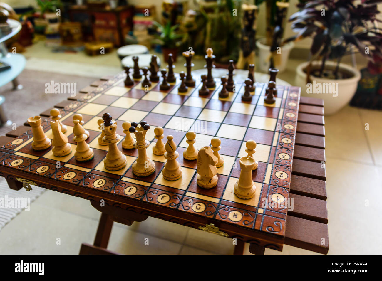 Wooden chessboard inside a trendy modern house. Stock Photo