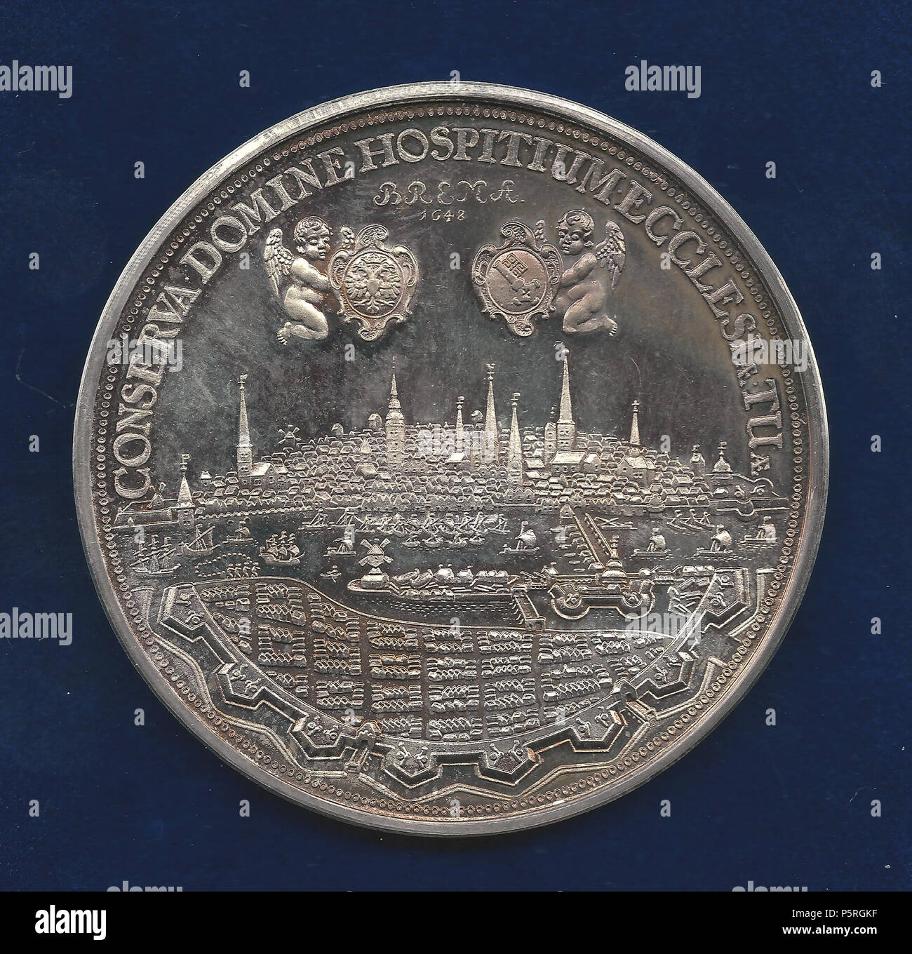 N/A. English: Medallion d. = 56 mm. 48.69 g Ag 1.000 Fine Silver Commemorating the Peace of Westphalia after the Thirty Years' War Curved above the Bremen Roland: 'STATUA ROLANDI BREMENSIS'/ City view with a bridge over the river Weser with ships. Above 2 flying angels holding the shields of the emperor l., and of the Free City of Bremen r., and dividing 2 lines: 'BREMA 1648'. Curved above: 'CONSERVA DOMINE HOSPITIUM ECCLESIÆ TUÆ'. Forrer I, p. 201. According to legend, Bremen will remain free and independent for as long as Roland stands watch over the city. For this reason, it is alleged that Stock Photo