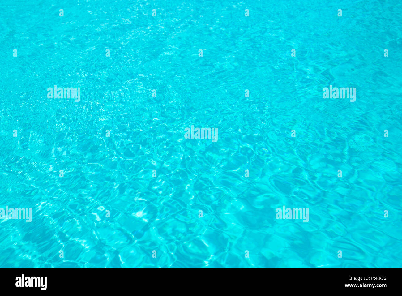 Turquoise blue ripped swimming pool water background, summer concept Stock Photo