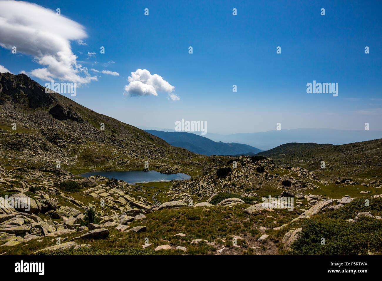 Scenery summer rocky landscape with a tiny lake with crystal clear waters, Pirin Mountain, Bulgaria Stock Photo