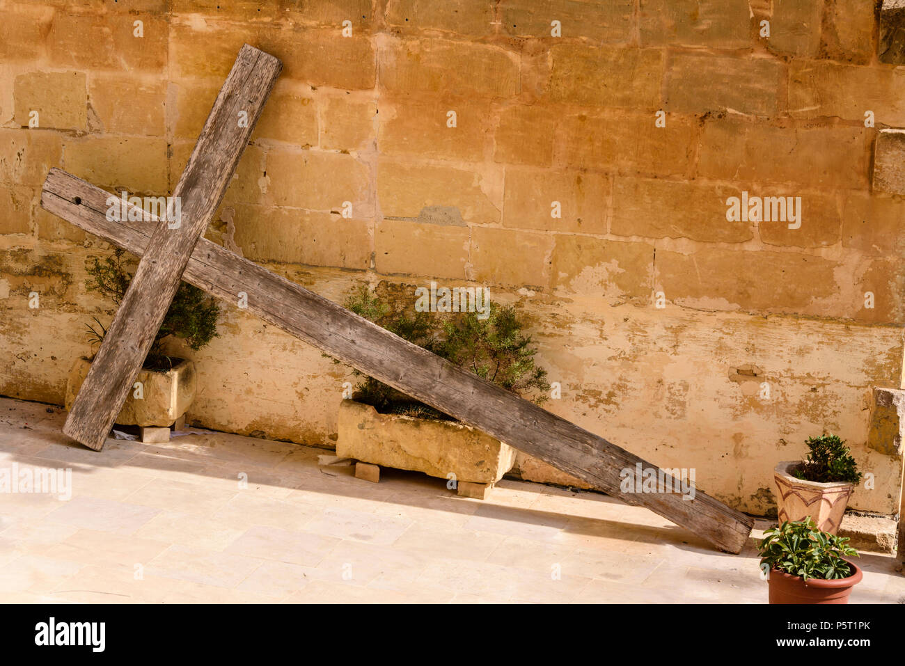 A Large Wooden Cross Lies Propped Up Against A Wall Outside A House In Gozo Malta Stock Photo Alamy