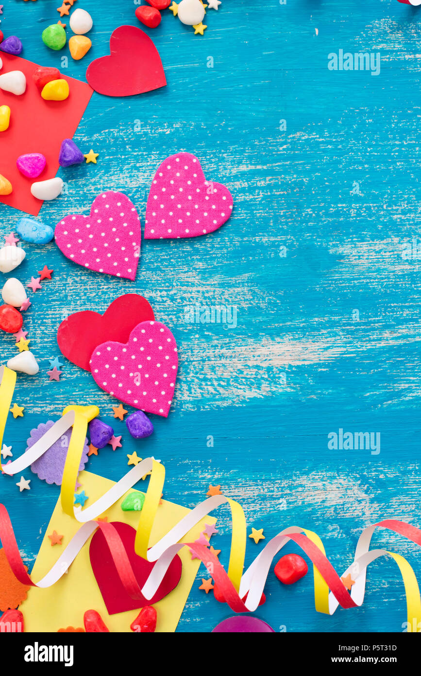 Festive confetti background heart candy color saturated. Wood old blue background with copy space flat lay Stock Photo