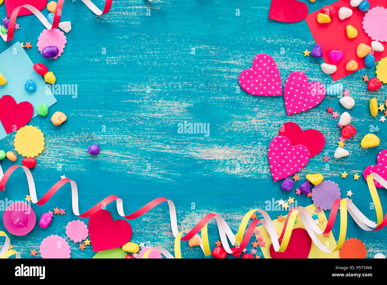 Festive confetti background heart candy color saturated. Wood old blue background with copy space flat lay Stock Photo