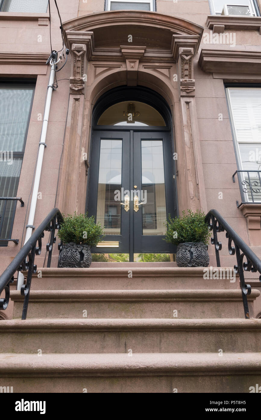 Brownstone terrace door and cast iron railings early 20th century American architecture in