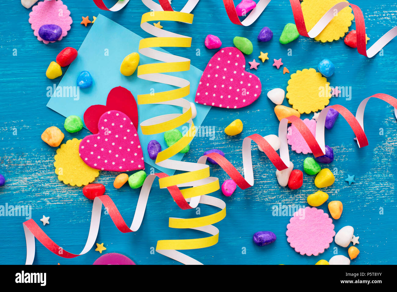 Festive confetti background heart candy color saturated. Wood old blue background with copy space flat lay Stock Photo