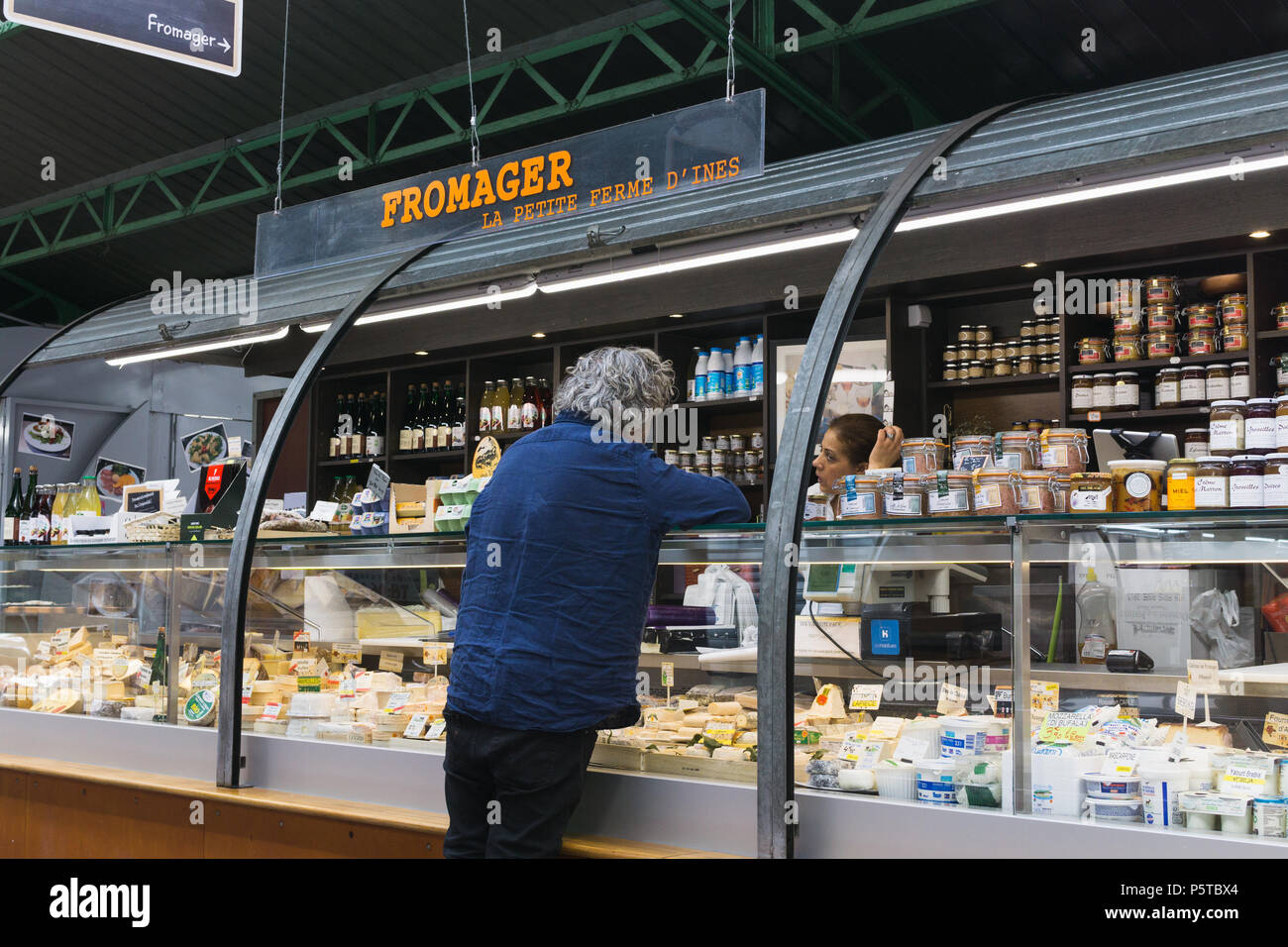 Cheese for sale in a Paris cheese shop (fromagerie) at the Enfants Rouges market, France. Stock Photo