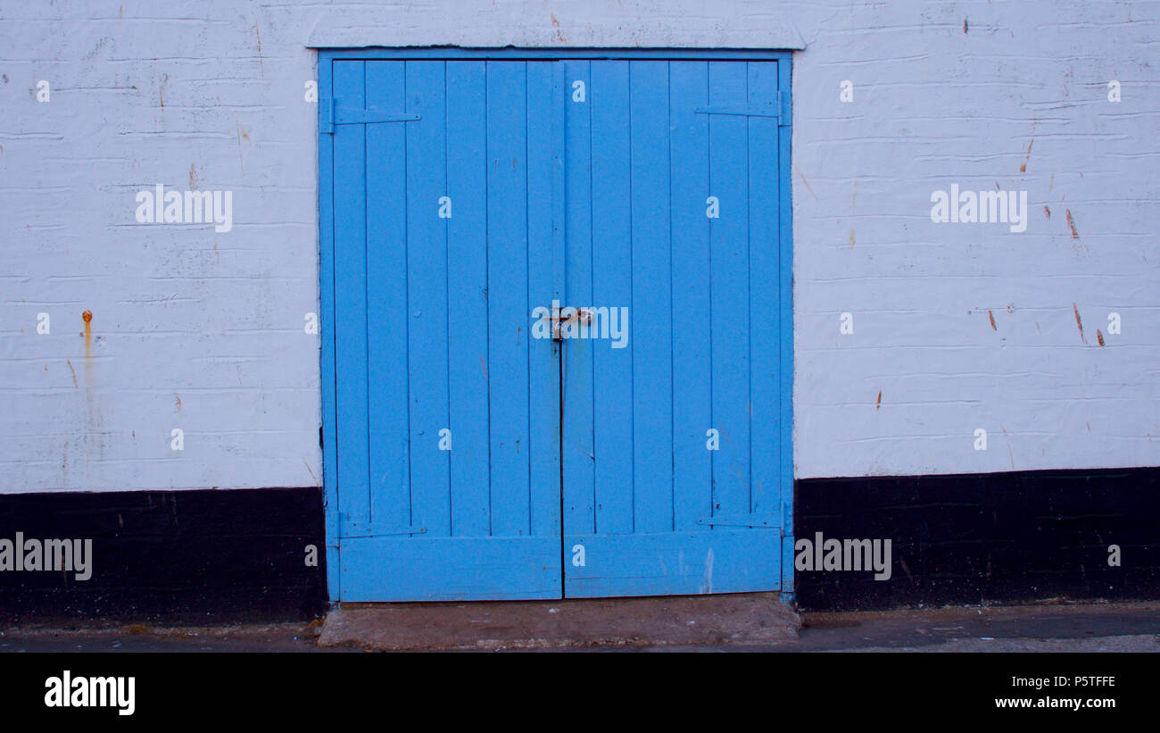 Fishermans lock ups on the harbour side Stock Photo Alamy