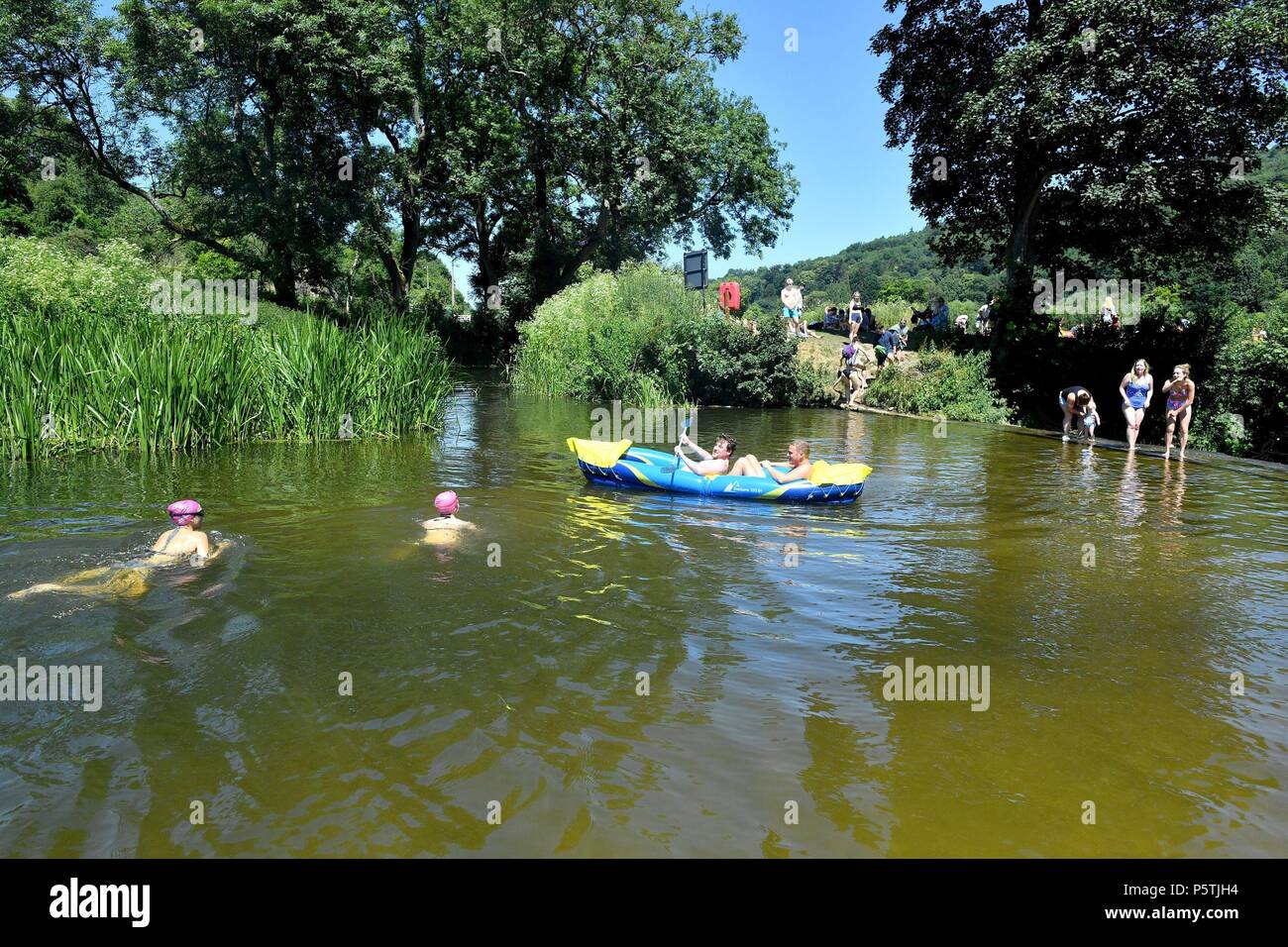 People take an inflatable kayak to Warleigh Weir, near Claverton outside Bath. Stock Photo