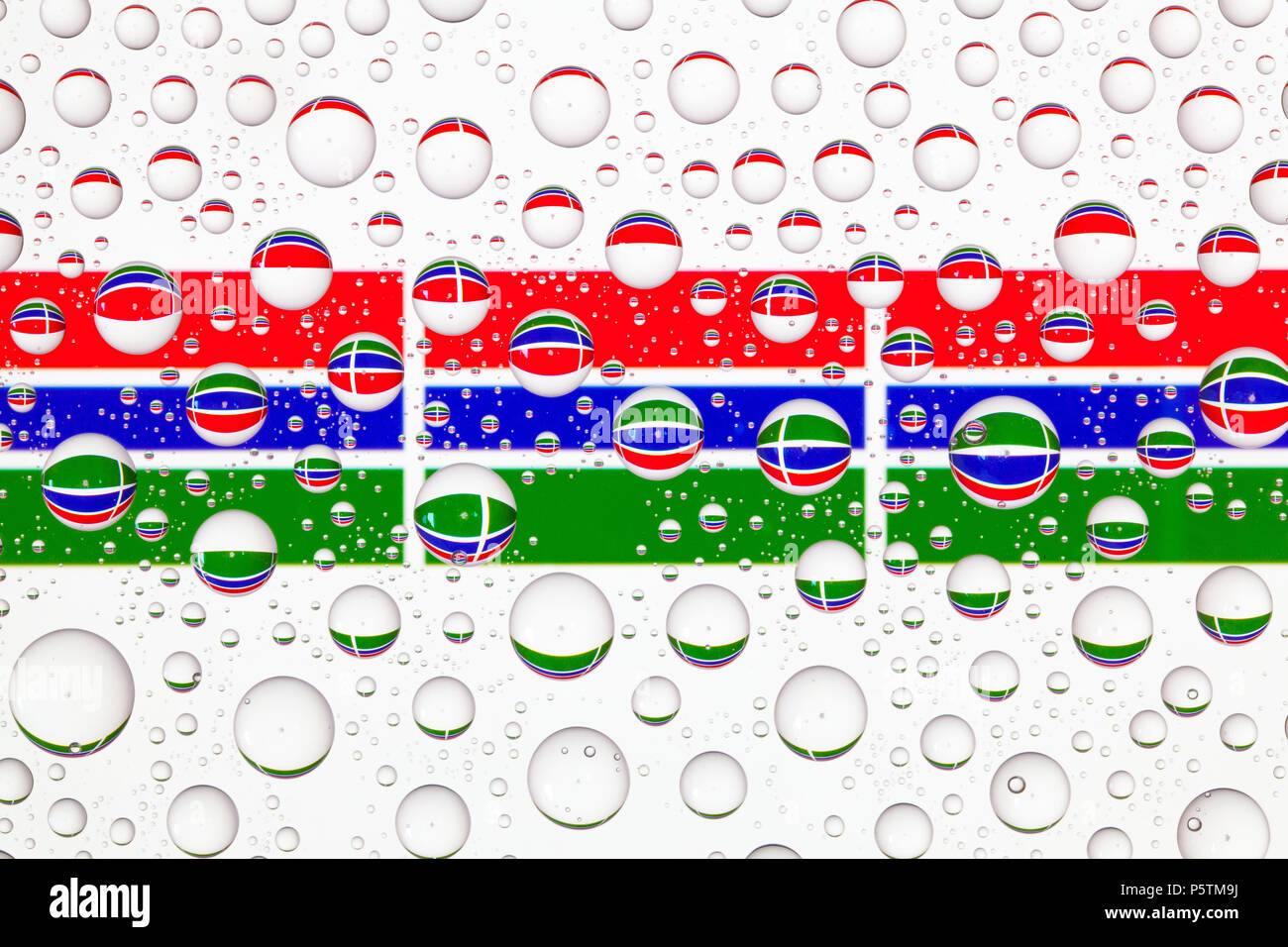 Flags of Gambia behind a glass covered with raindrops Stock Photo - Alamy