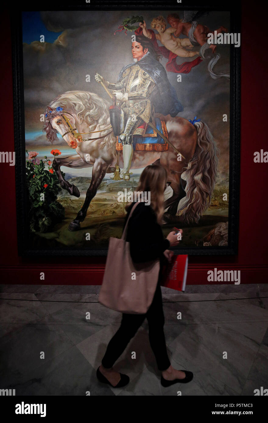 A visitor looking at Kehinde Wiley's Equestrian Portrait of King Philip II (Michael Jackson), 2010, during a press preview of Michael Jackson: On the Wall exhibition at the National Portrait Gallery in London. Stock Photo