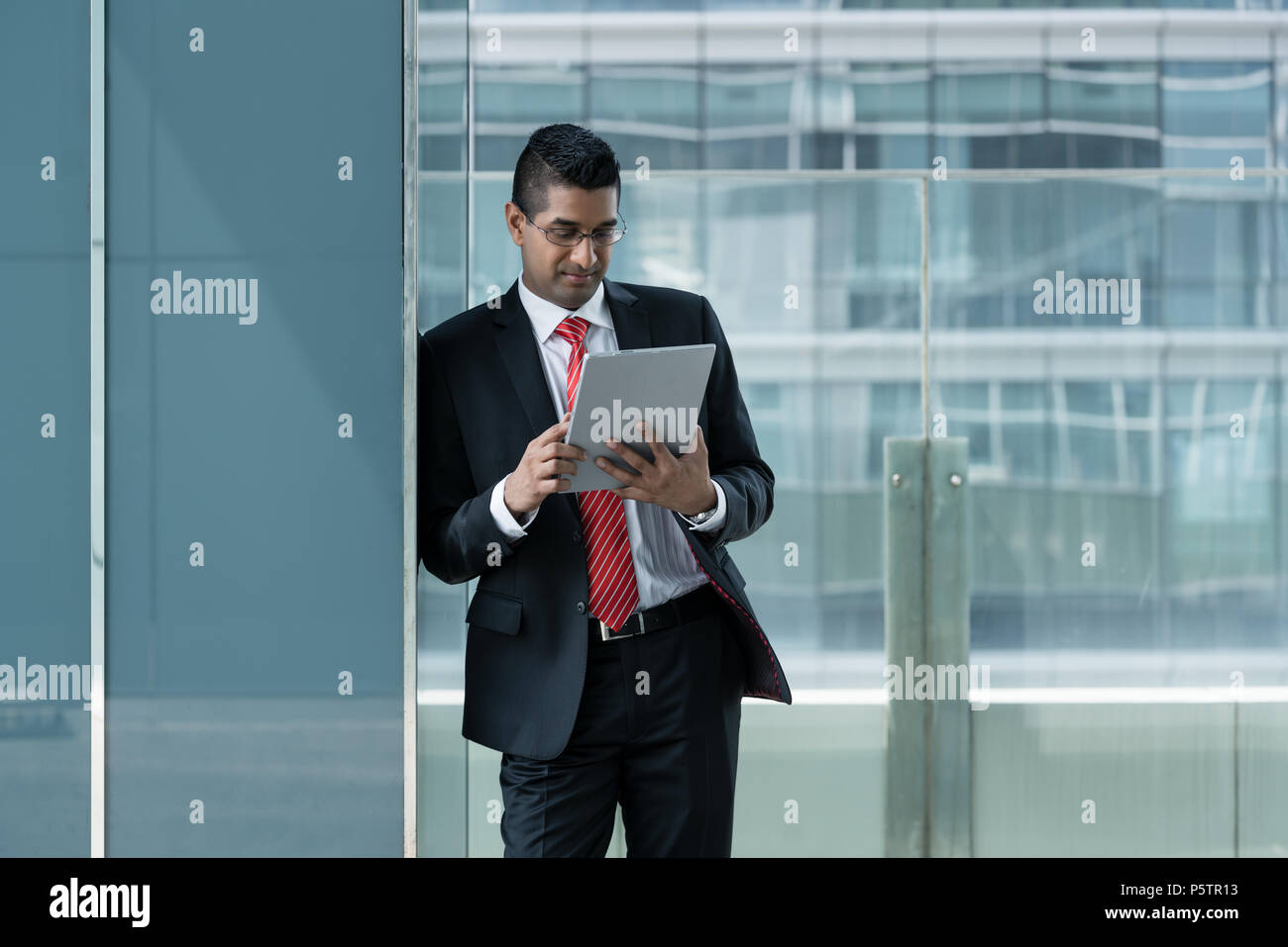 Indian businessman using a tablet PC indoors Stock Photo