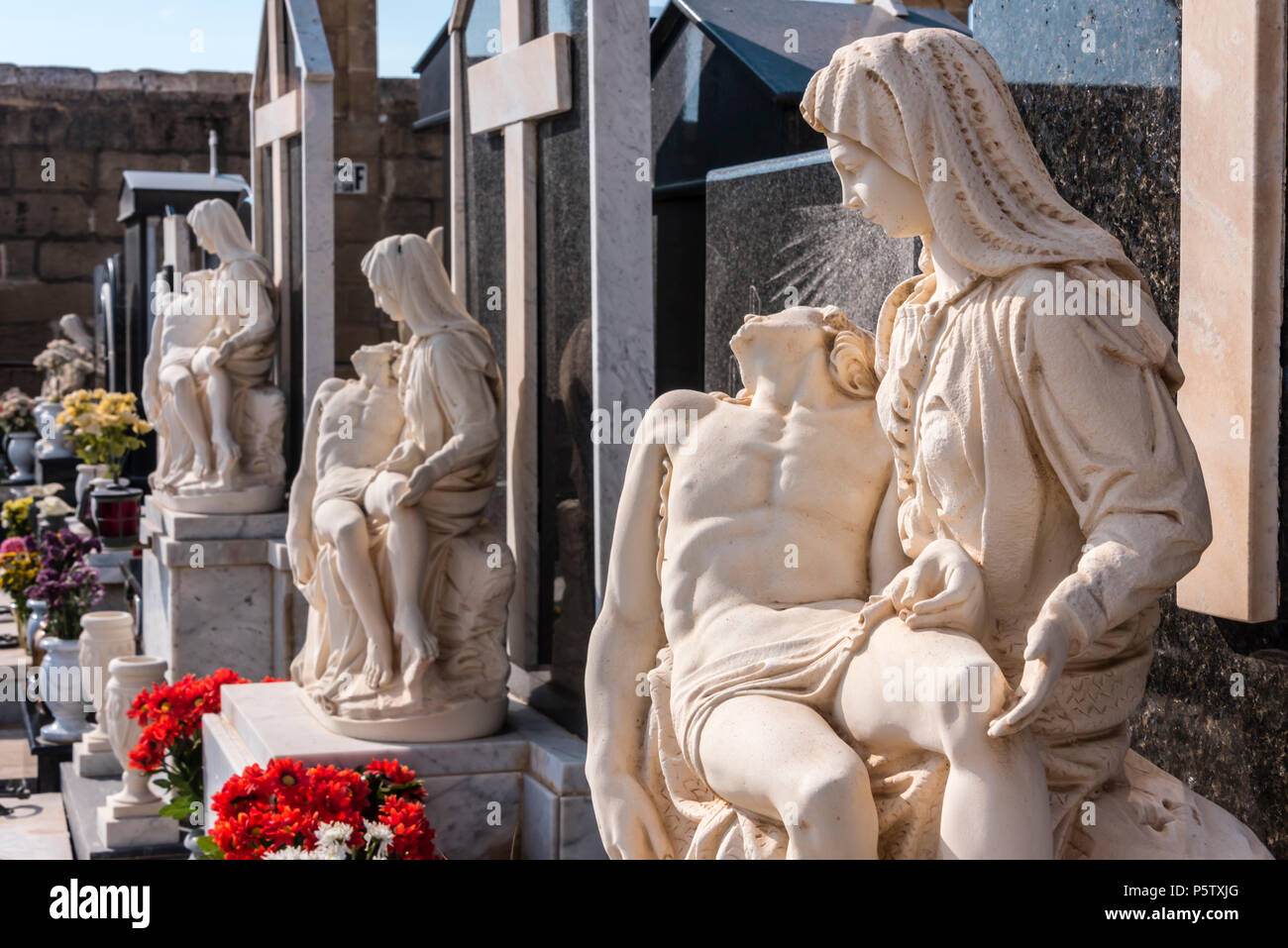 Roman Catholic cemetery with ornate carved marble and granite headstones, Xwekija, Gozo, Malta. Stock Photo