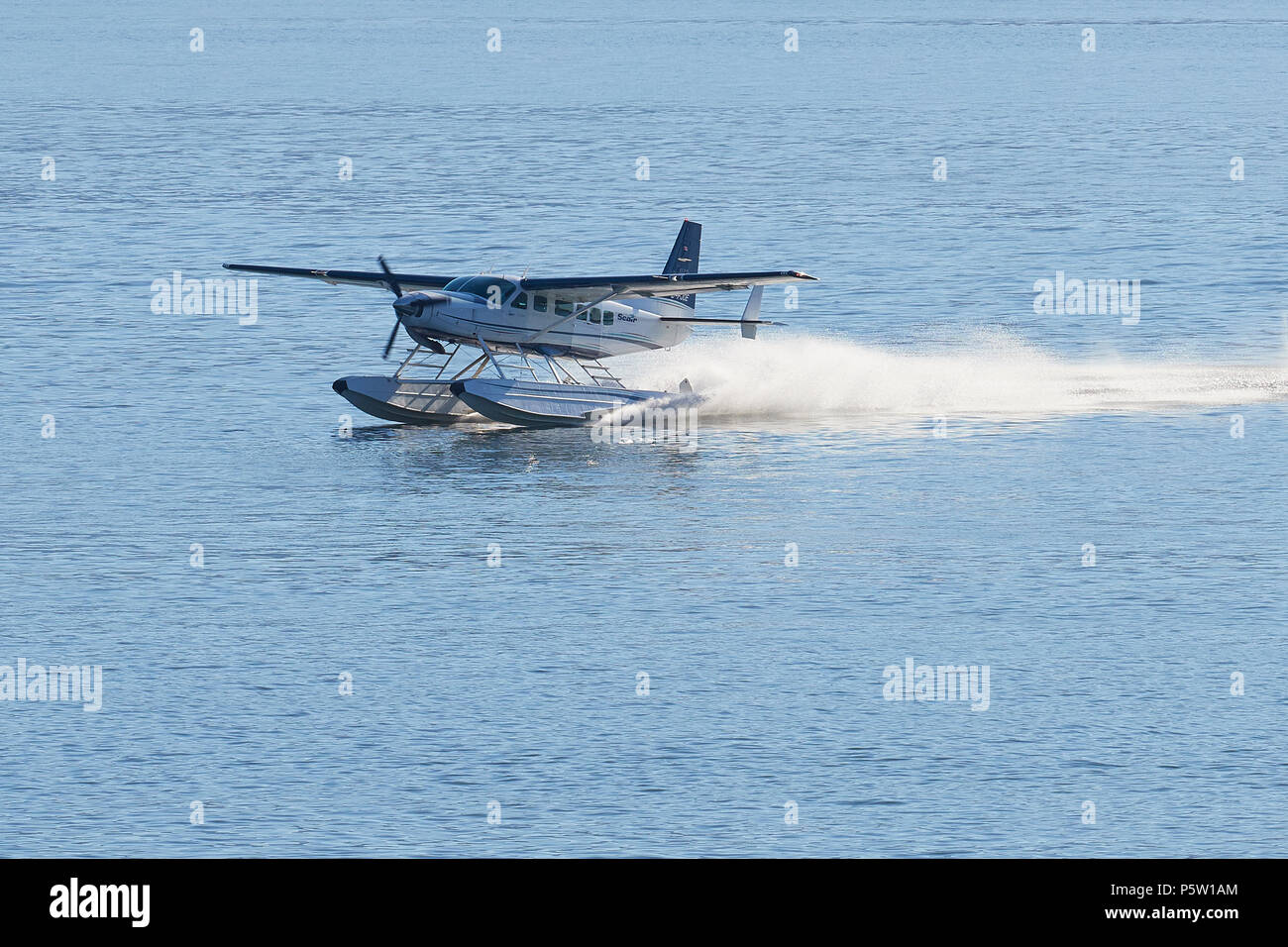 Seair Seaplanes Cessna 208 Caravan Float Plane Landing On The Water At The Vancouver Harbour Airport, BC, Canada. Stock Photo