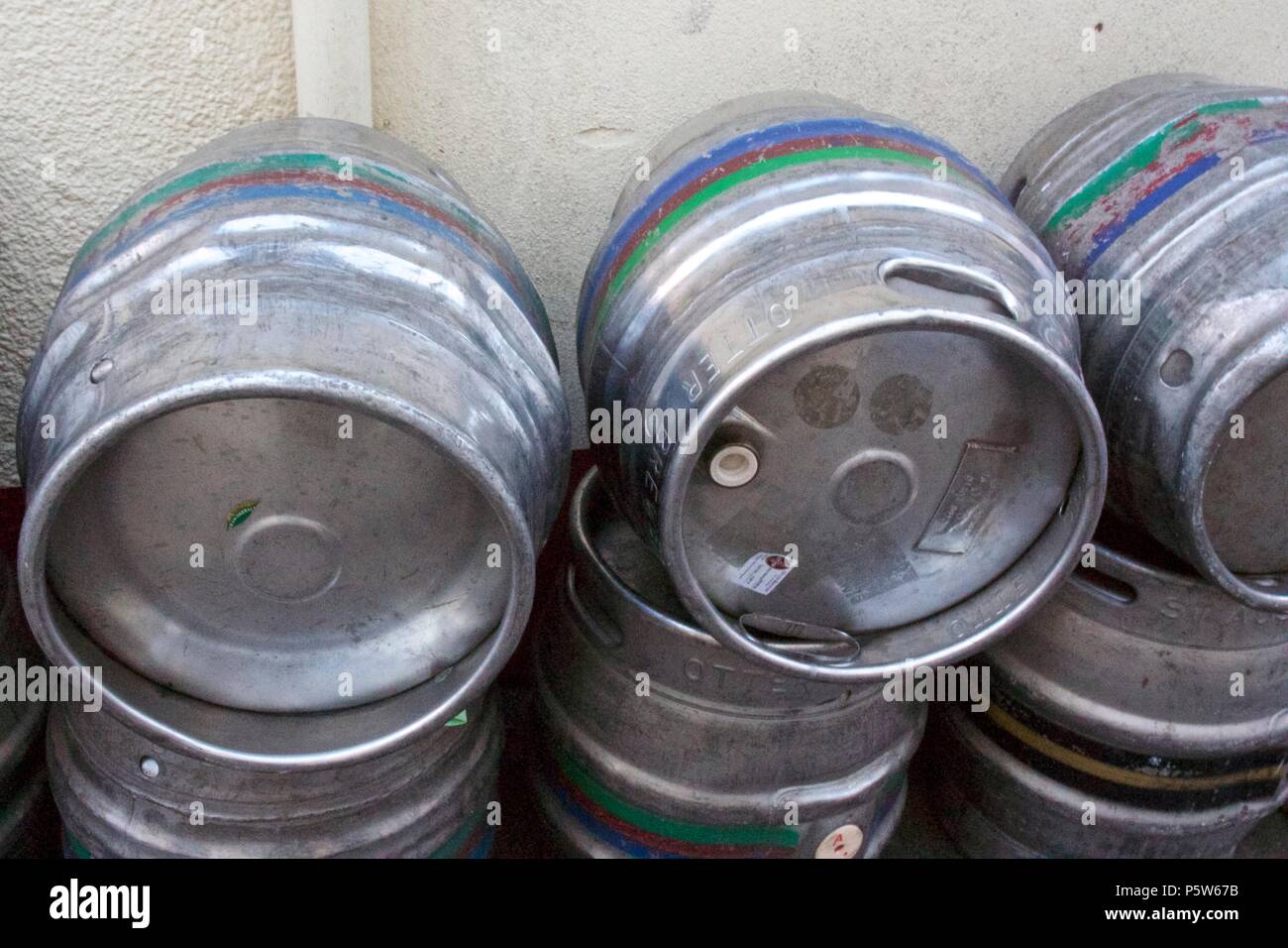 Stacked empty beer kegs outside a pub Stock Photo
