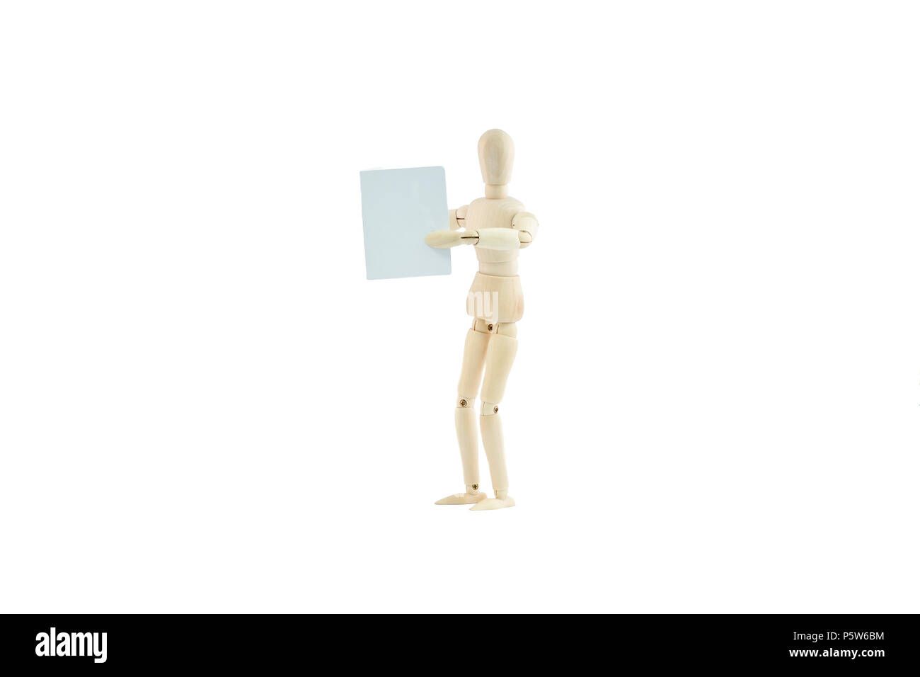 articulated wooden dummy reading the newspaper, isolated on white