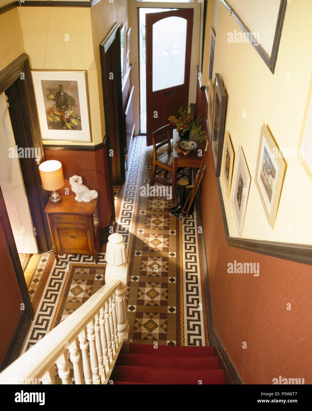 Original Victorian tessellated tiled floor in period townhouse hall with brown dado wall Stock Photo