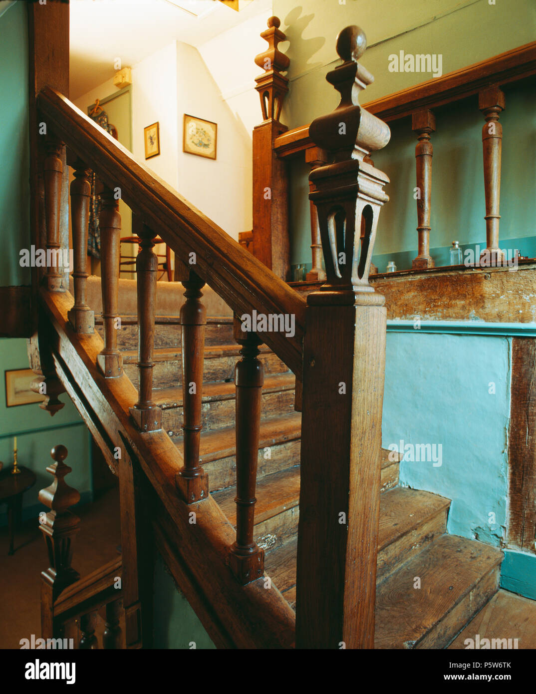 Ornate carved oak newel post on banisters on oak staircase Stock Photo