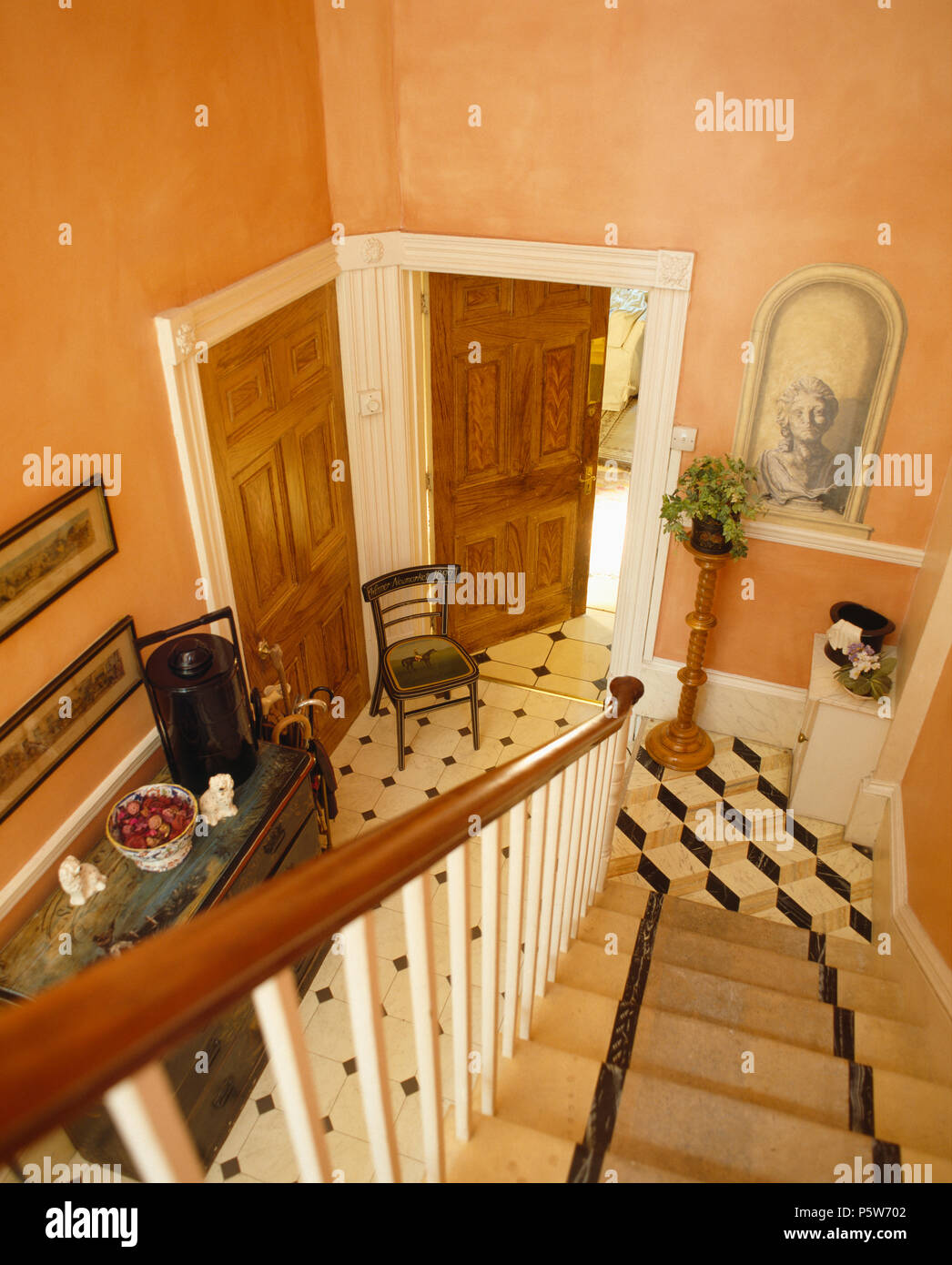 Birds-eye view of peach painted hall with trompe-l'oiel alcove and chequer-board flooring Stock Photo