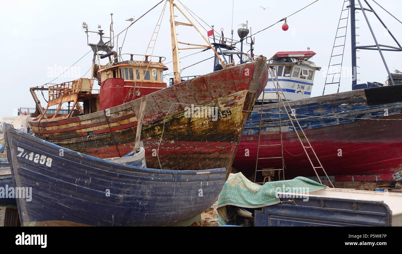 Fishing trawlers and boats in dock at Essaouira, Morocco. Some ready to be repaired and re-fitted. Stock Photo
