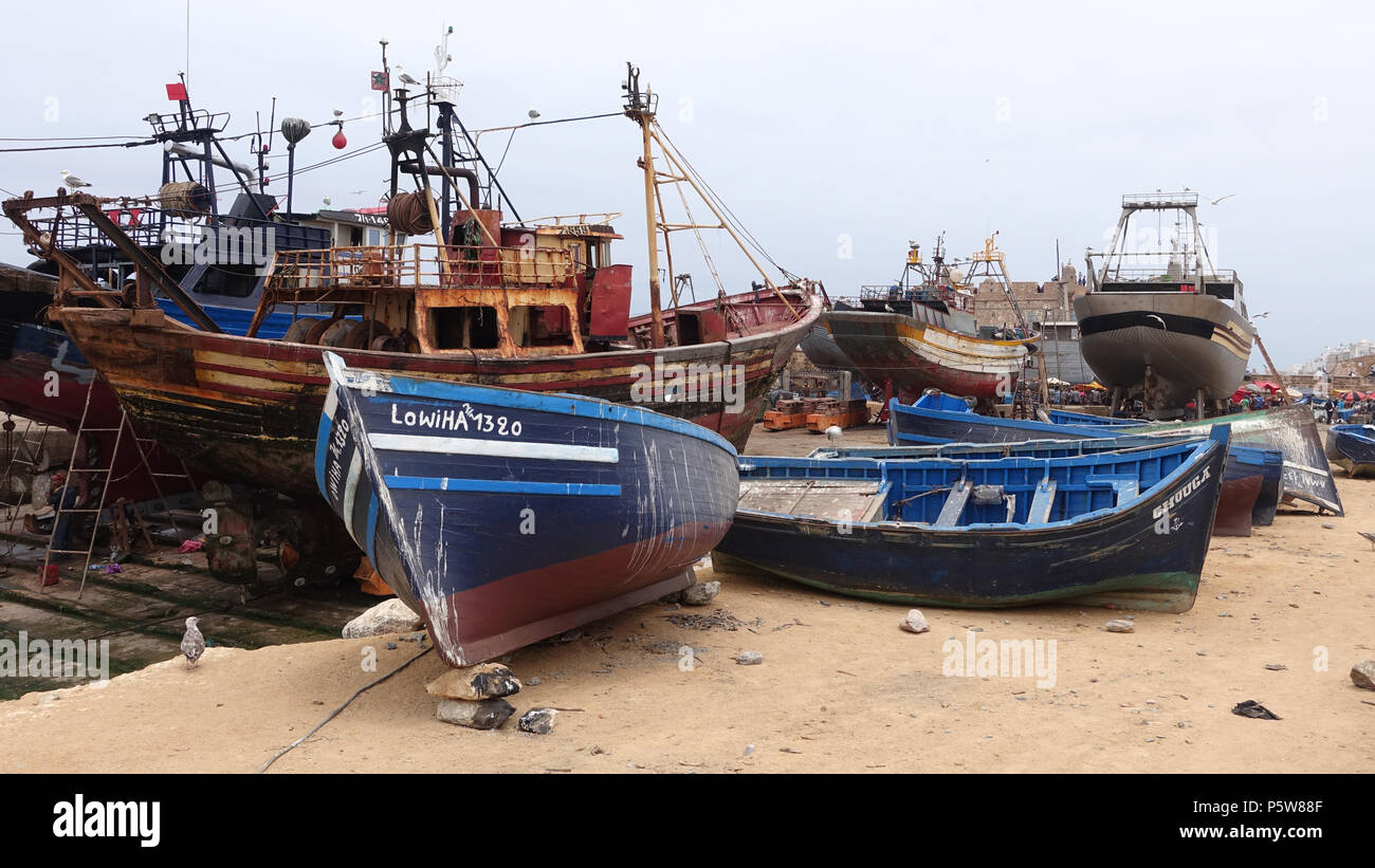 Fishing trawlers and boats in dock at Essaouira, Morocco. Some ready to be repaired and re-fitted. Stock Photo