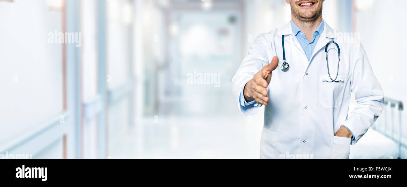 happy friendly doctor standing in hospital hallway. trust and partnership concept Stock Photo