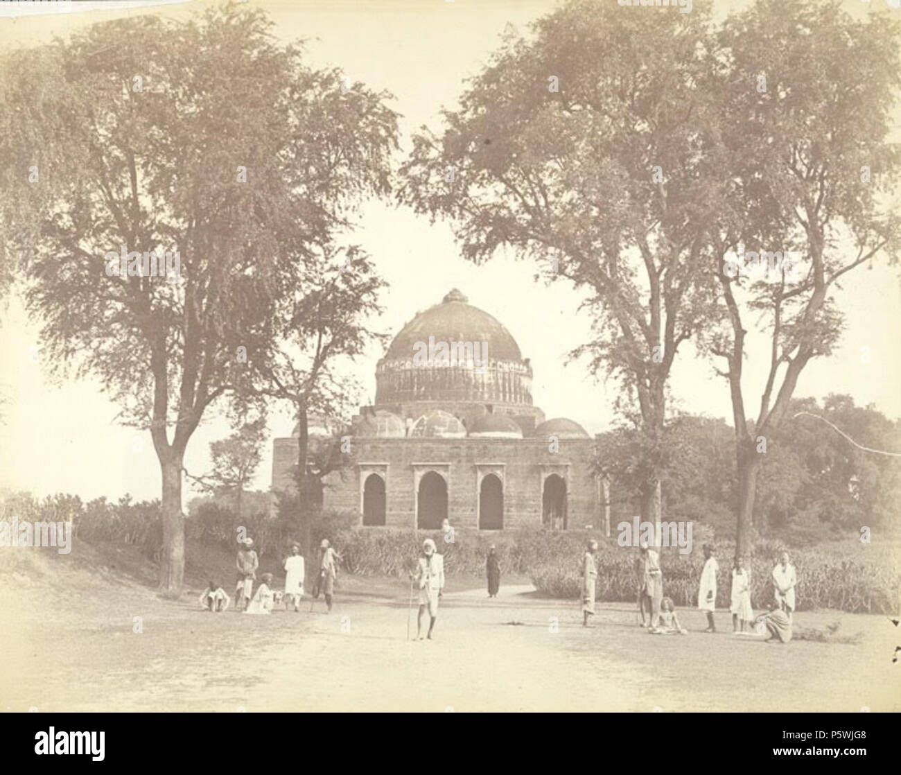 N/A. English: This signed photograph was taken by Charles Lickfold in 1880s. The image shows the tomb of Darya Khan, which now lies in the northern suburbs of modern-day Ahmadabad. It was built in 1453 whilst the city was the capital of the thriving sultanate of Gujarat. The majority of tombs of the period in Gujarat are built using local post and lintel or trabeate methods of construction in yellow sandstone. This tomb differs in two ways: first, it is built using baked brick; and secondly, its architects chose to use true arches and domes according to arcuate methods to create a cavernous in Stock Photo