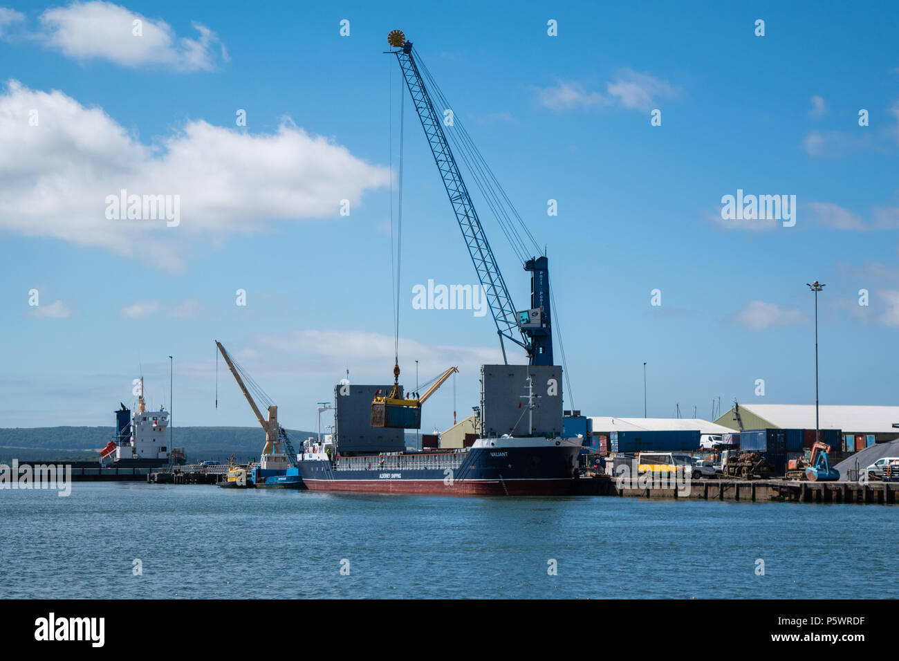 The Valiant - Alderney Shipping Company - Channel Seaways Lineage Ship being loaded with shipping containers on a sunny Summers Day in June 2018. Stock Photo