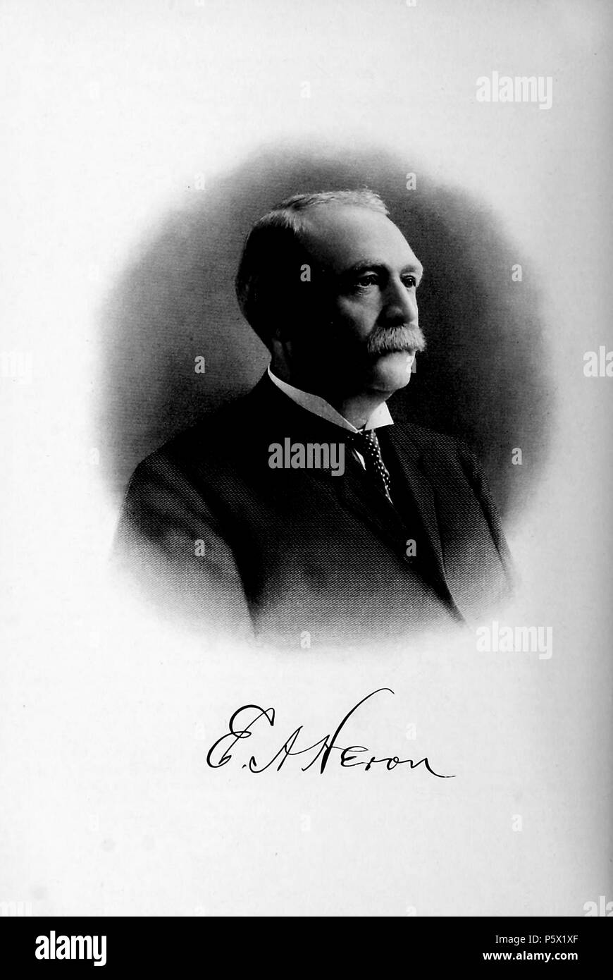 Black and white portrait photograph of the president of the Oakland Traction Company, Ernest A Heron, shown in three-quarter profile view, from the chest up, with a serious expression on his face, a neatly groomed mustache, and wearing a dark suit and polka dotted tie, from the volume 'History of the State of California and Biographical Record of Oakland and Environs, ' authored by JM (James Miller) Guinn, and published in Los Angeles by the Historic Record Co, 1907. Courtesy Internet Archive. () Stock Photo