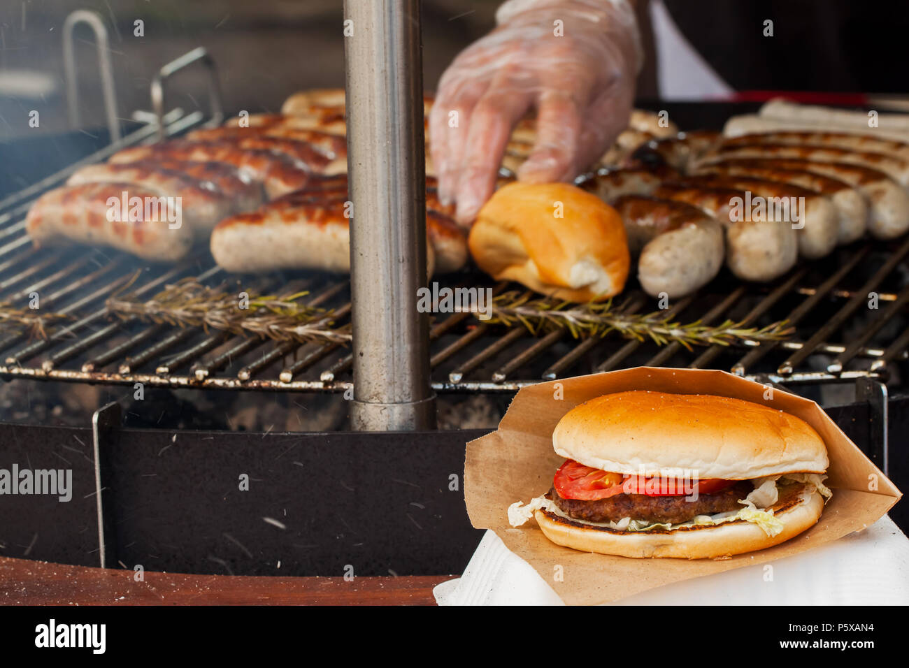 Sausage and burgers on a grill pan Stock Photo Alamy