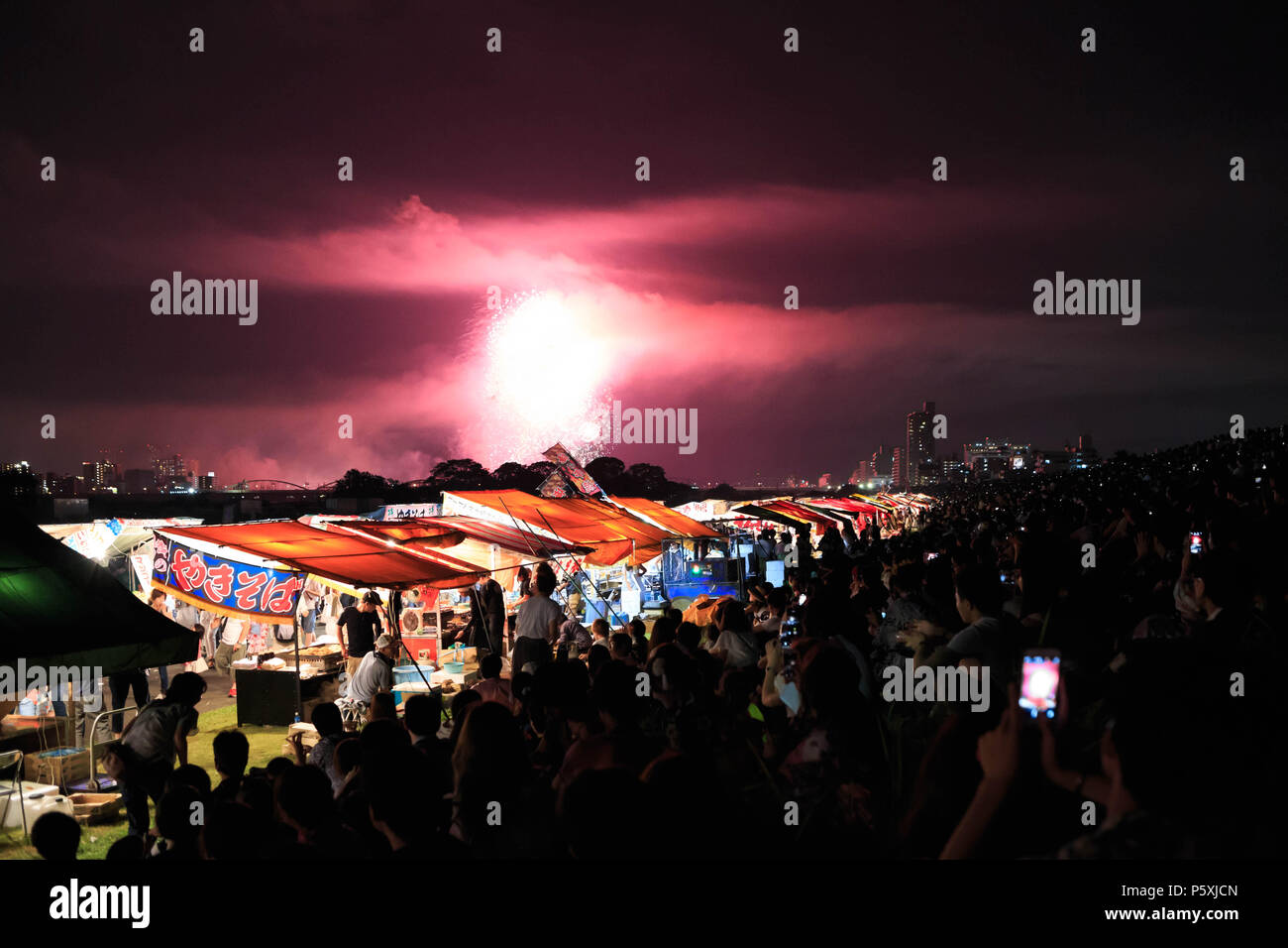 Osaka, Japan - August, 8 2015: Spectators take photos with phones of the Yodogawa Fireworks display Stock Photo