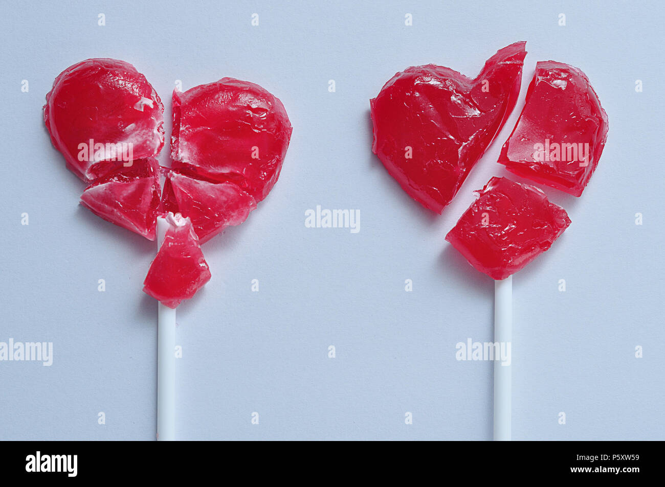 Two broken red heart lollipops symbolizing broken hearts Stock Photo ...