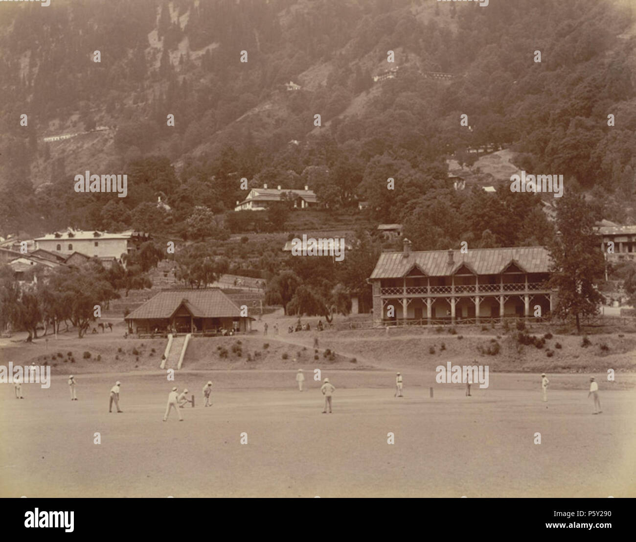 N/A. English: Photograph of a Cricket Match at Nainital from the Macnabb Collection (Col James Henry Erskine Reid): Album of views of 'Naini Tal' taken by Lawrie & Company in 1899. The area of the Kumaon Hills had come under British rule after the Anglo-Nepal War (1814-16) but it wasn't until 1841 that P. Barron built the first European house in Nainital. The town became the summer headquarters of the colonial administration of the province. It was a popular retreat for the residents of the plains. Being popular with the British, the town developed a British character with several European sch Stock Photo